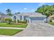 Charming single-Gathering home with a well-maintained lawn, gray paint, and a two-car garage at 12618 Lakebrook Dr, Orlando, FL 32828