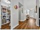 Inviting hallway showcasing hardwood floors, a pantry, and decorative furnishings at 12618 Lakebrook Dr, Orlando, FL 32828