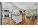 Open kitchen featuring granite countertops, stainless appliances and seamless flow into the living room at 12618 Lakebrook Dr, Orlando, FL 32828