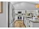 Updated kitchen showcases granite countertops, stainless steel appliances, and stylish white cabinetry at 12618 Lakebrook Dr, Orlando, FL 32828