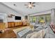 Bright living room boasts vaulted ceiling, modern decor, and seamless access to the outdoor patio at 12618 Lakebrook Dr, Orlando, FL 32828