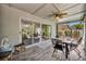 Spacious screened porch with a dining area and comfortable outdoor furniture, ideal for relaxation and gatherings at 12618 Lakebrook Dr, Orlando, FL 32828