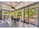 Inviting screened porch with dining table and outdoor seating, perfect for enjoying nature and entertaining guests at 12618 Lakebrook Dr, Orlando, FL 32828