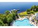 An aerial view shows a luxury community, a pool, and a dock on the lake at 13415 Blue Heron Beach Dr # 1503, Orlando, FL 32821