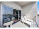 Balcony with lake views, lounge chairs, and table at 13415 Blue Heron Beach Dr # 1503, Orlando, FL 32821