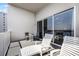Balcony featuring two lounge chairs, small table set, and sliding glass doors at 13415 Blue Heron Beach Dr # 1503, Orlando, FL 32821