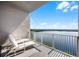 Serene balcony with two lounge chairs overlooking a scenic waterfront view, ideal for relaxation at 13415 Blue Heron Beach Dr # 1503, Orlando, FL 32821