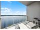 Spacious balcony with lake views, lounge chairs, and a table at 13415 Blue Heron Beach Dr # 1503, Orlando, FL 32821
