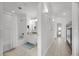 A bathroom with a vanity, commode, and shower/tub combination is visible from a hallway at 13415 Blue Heron Beach Dr # 1503, Orlando, FL 32821