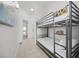 Charming bedroom featuring twin bunk beds, cartoon wall decor, and neutral tile flooring at 13415 Blue Heron Beach Dr # 1503, Orlando, FL 32821