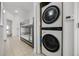 Hallway featuring a stacked washer/dryer, a bunk bed, and light tile flooring at 13415 Blue Heron Beach Dr # 1503, Orlando, FL 32821