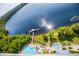High-angle shot of a large lake, a pier, and resort-style swimming pools with lush vegetation nearby at 13427 Blue Heron Beach Dr # 2003, Orlando, FL 32821
