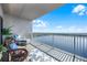 Serene lake view from the condo's balcony with comfortable outdoor seating and lush greenery at 13427 Blue Heron Beach Dr # 2003, Orlando, FL 32821