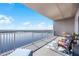 Expansive lake view from the condo's private balcony with stylish outdoor furniture at 13427 Blue Heron Beach Dr # 2003, Orlando, FL 32821