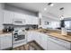 Efficient kitchen features white cabinets, granite countertops, and modern appliances at 13427 Blue Heron Beach Dr # 2003, Orlando, FL 32821