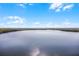 Scenic wide angle shot of a tranquil lake surrounded by lush greenery under a bright sky at 13427 Blue Heron Beach Dr # 2003, Orlando, FL 32821