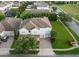 Two-story home with a three-car garage and lush landscaping in a suburban community at 14572 Black Quill Dr, Winter Garden, FL 34787