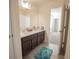 Bathroom with double vanity, spacious mirror, tiled flooring, and a shower with a decorative curtain at 14572 Black Quill Dr, Winter Garden, FL 34787