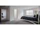 Well-lit bedroom with natural light, carpeted floors, and a minimalist design creating a calm and relaxing atmosphere at 14572 Black Quill Dr, Winter Garden, FL 34787
