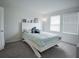 Bedroom features natural light, carpeted floor, and neutral color palette that offers a comfortable and welcoming space at 14572 Black Quill Dr, Winter Garden, FL 34787