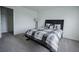 Stylish bedroom with a modern black bed, carpeted floors, a lamp, and decor elements creating a cozy and relaxing space at 14572 Black Quill Dr, Winter Garden, FL 34787