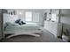 Bright bedroom with large windows, white furniture, carpeted floors, and stylish decor creating a serene atmosphere at 14572 Black Quill Dr, Winter Garden, FL 34787
