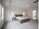 Bright bedroom with carpet flooring, a modern headboard, side tables and lamps, and white walls at 14572 Black Quill Dr, Winter Garden, FL 34787