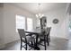 Cozy dining room featuring a modern chandelier, neutral decor, and tile floors with a view to the kitchen at 14572 Black Quill Dr, Winter Garden, FL 34787