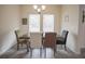 Bright dining room with neutral-toned chairs and a wooden table at 14572 Black Quill Dr, Winter Garden, FL 34787