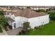 Gray two-story home with a brown roof, well-maintained lawn, and paved driveway to a 2-car garage at 14572 Black Quill Dr, Winter Garden, FL 34787