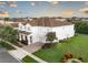 Spacious two-story gray home with a brown roof, manicured landscaping, and an attached two-car garage at 14572 Black Quill Dr, Winter Garden, FL 34787
