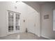 Bright foyer with tile flooring, a high ceiling, and french doors leading to a bonus room at 14572 Black Quill Dr, Winter Garden, FL 34787