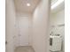 Hallway leading to laundry room with a new, front load washer and dryer at 14572 Black Quill Dr, Winter Garden, FL 34787