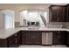 Kitchen with white countertops, stainless steel appliances, and dark cabinetry at 14572 Black Quill Dr, Winter Garden, FL 34787