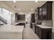 Open kitchen with a center island, stainless steel appliances, and modern dark cabinetry at 14572 Black Quill Dr, Winter Garden, FL 34787