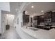 Modern kitchen showcasing white countertops, dark cabinetry, and stainless steel appliances at 14572 Black Quill Dr, Winter Garden, FL 34787