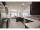 Stylish kitchen with modern appliances, dark cabinetry, white countertops, and tiled floors at 14572 Black Quill Dr, Winter Garden, FL 34787