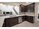 Modern kitchen featuring dark wood cabinets, stainless steel appliances, and a beautiful backsplash at 14572 Black Quill Dr, Winter Garden, FL 34787