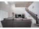 Spacious living area with stairs, a gray sofa, and high ceilings at 14572 Black Quill Dr, Winter Garden, FL 34787