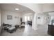 Bright living room with tile floors, large windows, neutral decor, and arched doorways to the rest of the home at 14572 Black Quill Dr, Winter Garden, FL 34787