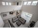 Open concept living area featuring a modern gray sectional sofa and an adjacent dining space at 14572 Black Quill Dr, Winter Garden, FL 34787