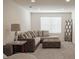 Comfortable living room featuring a plush sectional sofa, ottoman, neutral color palette, and ample natural light at 14572 Black Quill Dr, Winter Garden, FL 34787