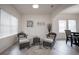Bright living room with large windows, tile flooring, and neutral-colored furnishings and decor at 14572 Black Quill Dr, Winter Garden, FL 34787