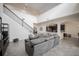 Bright living room with high ceilings, modern staircase, tile floors, and an open view of the kitchen at 14572 Black Quill Dr, Winter Garden, FL 34787