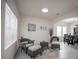 Bright and airy living room with large windows, tile flooring, and neutral-colored furnishings at 14572 Black Quill Dr, Winter Garden, FL 34787