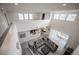 Bright, open living space featuring a modern gray sofa and large windows at 14572 Black Quill Dr, Winter Garden, FL 34787