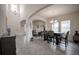 Open-concept living and dining area with tiled floors, abundant natural light, and neutral decor at 14572 Black Quill Dr, Winter Garden, FL 34787