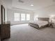 Large main bedroom featuring a tray ceiling, carpeted floors, and natural light at 14572 Black Quill Dr, Winter Garden, FL 34787