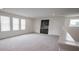 Upstairs landing with built in bar area, natural light, and neutral carpet at 14572 Black Quill Dr, Winter Garden, FL 34787