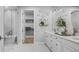 Bright bathroom with a glass-enclosed shower, soaking tub, and double vanity with marble countertops at 1613 Bellagio Loop, Tavares, FL 32778